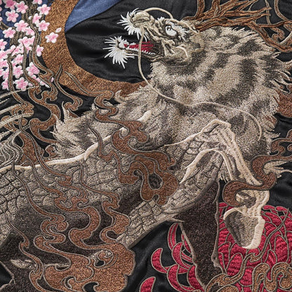 Textured embroidery of the large kirin body with smoke swirls over red chrysanthemum