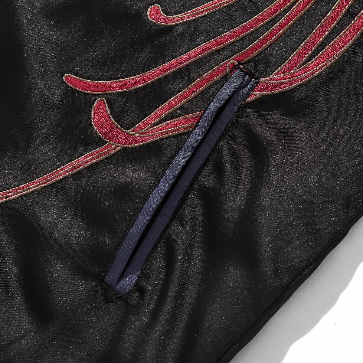 Front welt pocket with blue piping and flowing red chrysanthemum petals