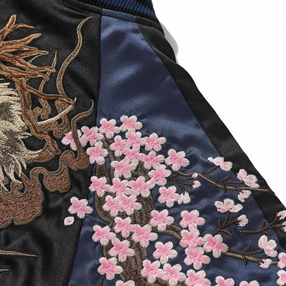 Navy sleeve panel with dense pink sakura blossoms and brown branch embroidery.