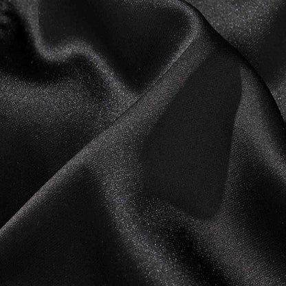 Satin fabric close-up of the reversible Lion & Sakura sukajan jacket, showing smooth, glossy weave texture.