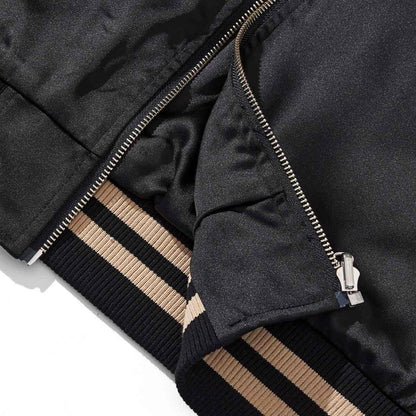 Ribbed hem and front zipper detail on the reversible Lion & Sakura sukajan jacket with clean stitching.
