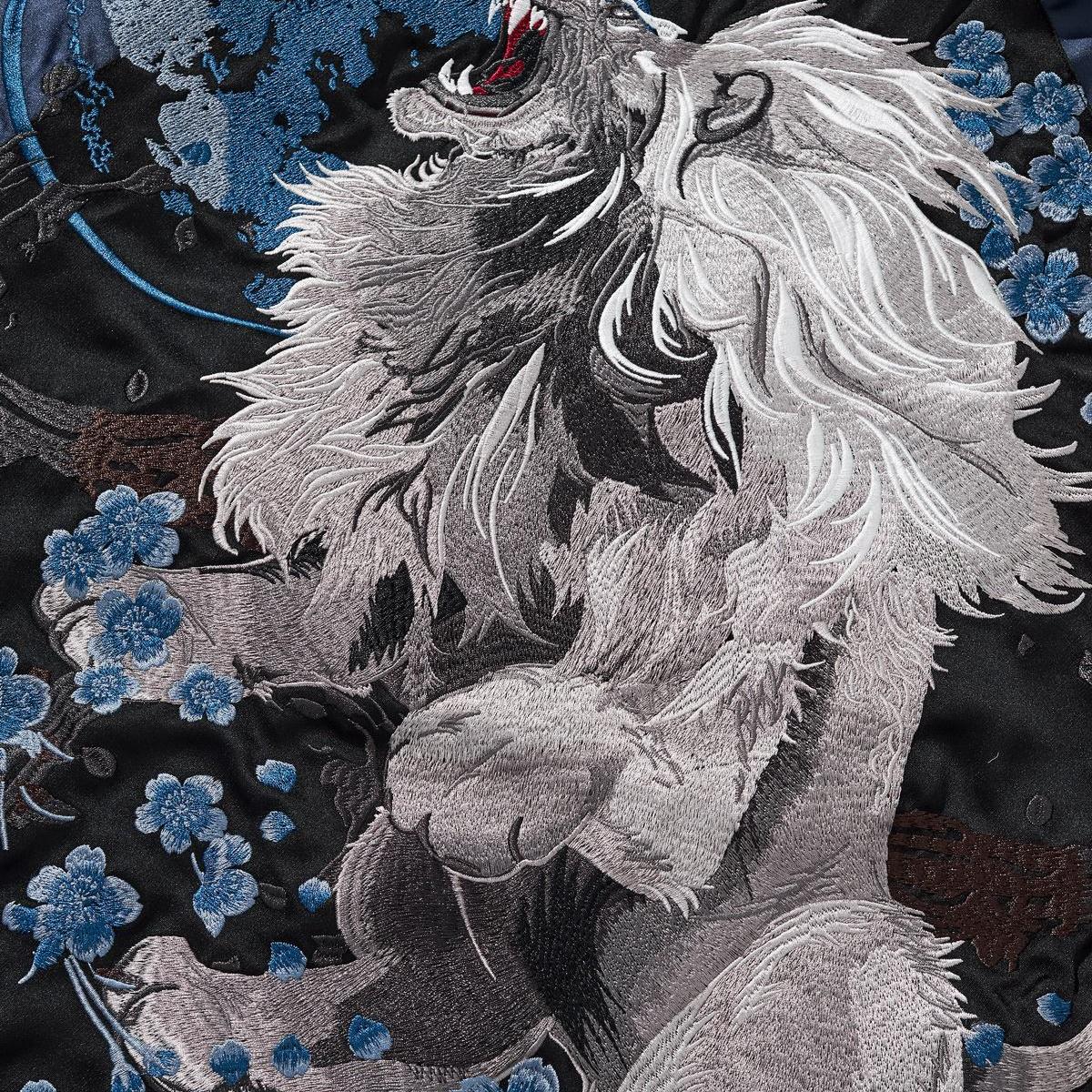 Back embroidery close-up showing the lion and clustered blossoms