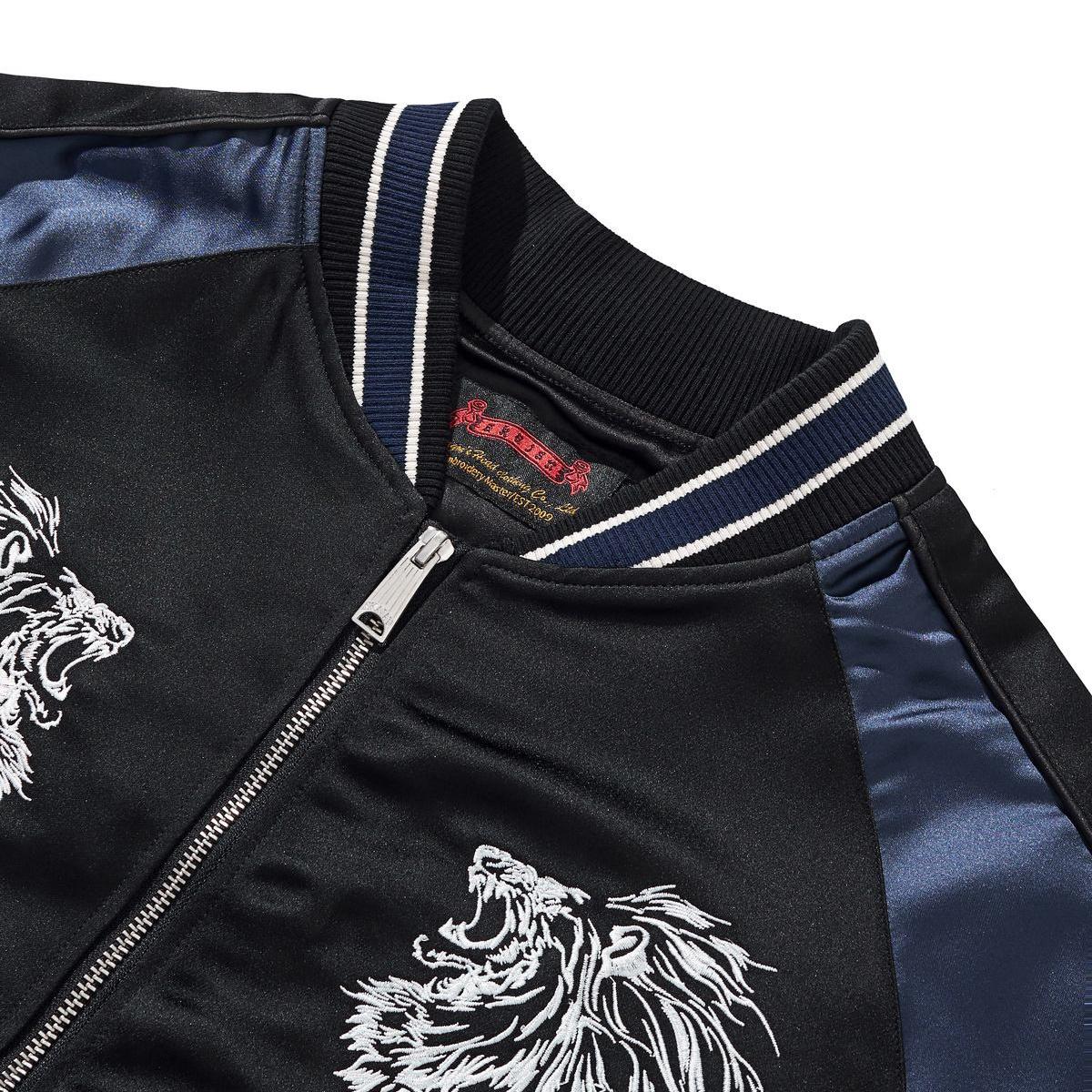 Ribbed collar close-up with contrast double stripe and smooth satin raglan