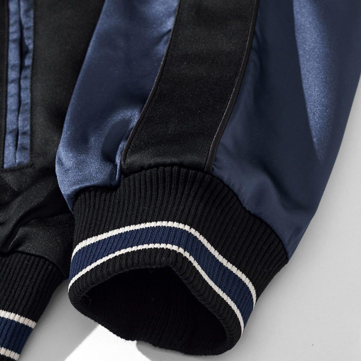 Ribbed cuff detail with navy-and-white stripe