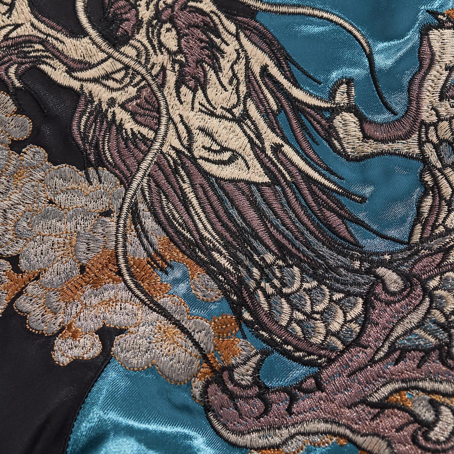 Macro photography showing the high-density silver thread texture of the dragon scales.