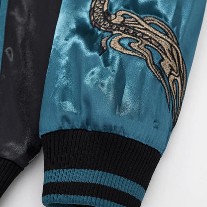 Close-up of the elastic ribbed cuff on the blue satin sleeve with dragon tail embroidery.