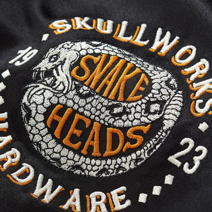 Close up of chest crest embroidery with coiled snake motif