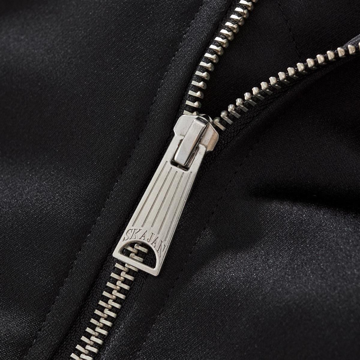 Metal zipper puller close-up with clean teeth