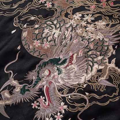 Close-up of storm dragon head embroidery with clouds and sakura