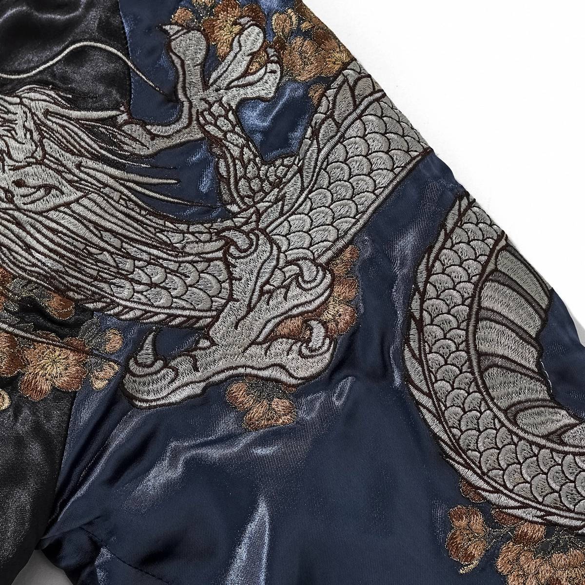 Close-up of storm dragon body and claws wrapping the navy sleeve on Storm Dragons & Peony sukajan jacket.