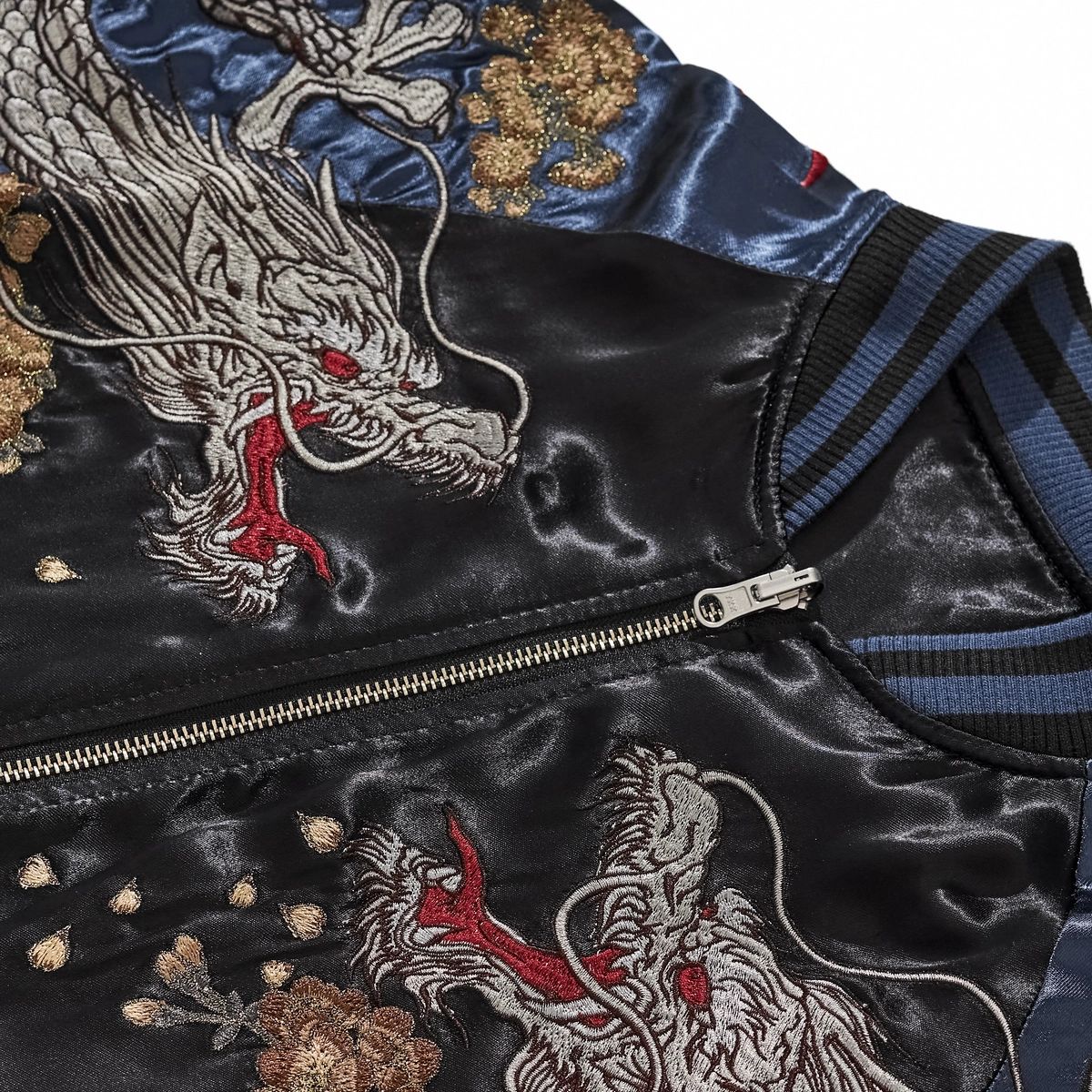 Close-up of twin storm dragon heads and chest zipper on navy Storm Dragons & Peony Japanese sukajan.