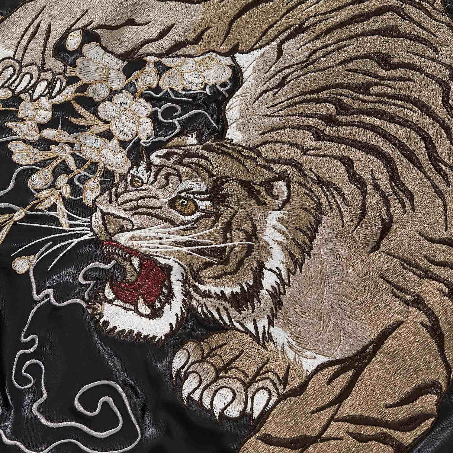 Close-up of tiger face and paw with blossoms and smoke lines.