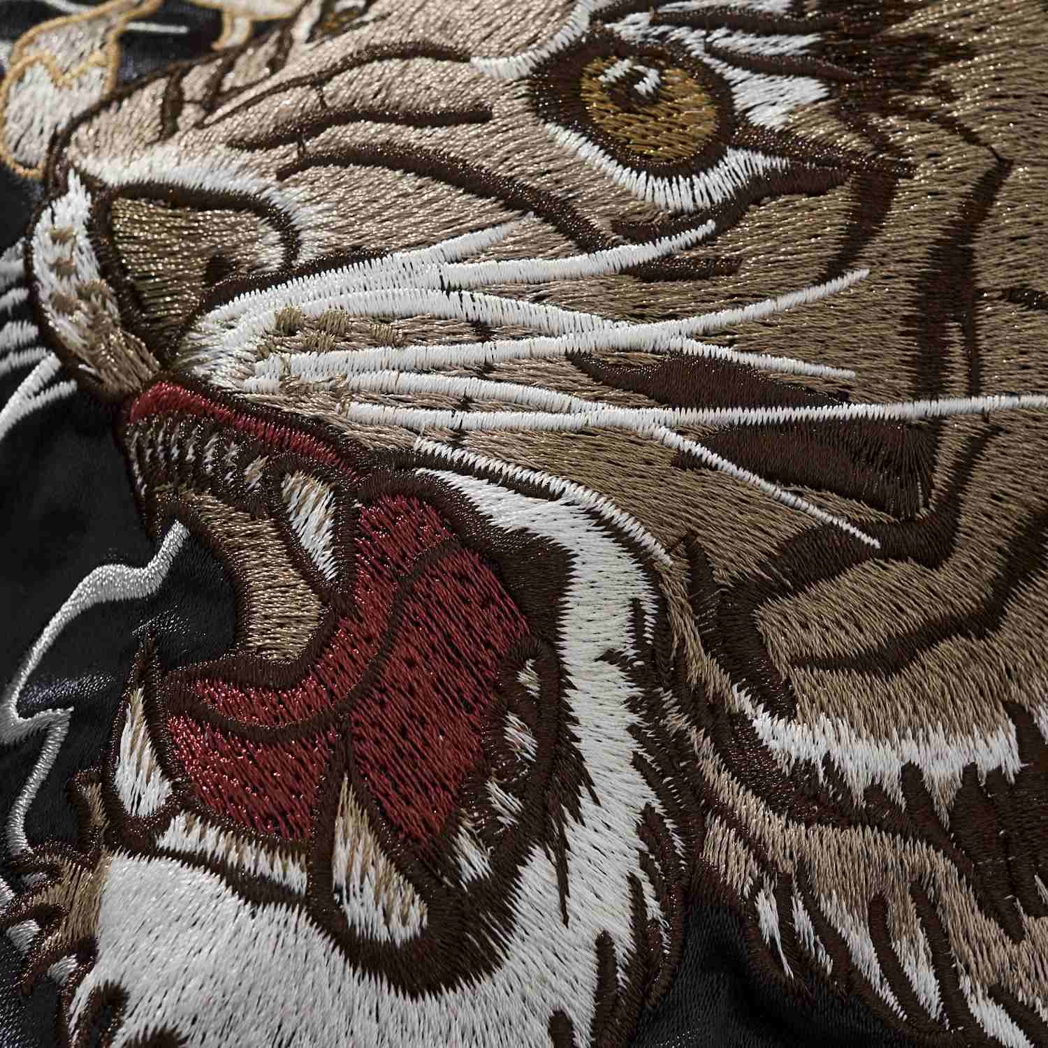 Stitch texture close-up of the tiger’s muzzle, teeth, and whiskers.