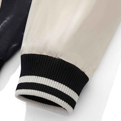 Close-up of beige satin sleeve and striped ribbed cuff on Twin Dragons & Sakura embroidered sukajan bomber jacket.