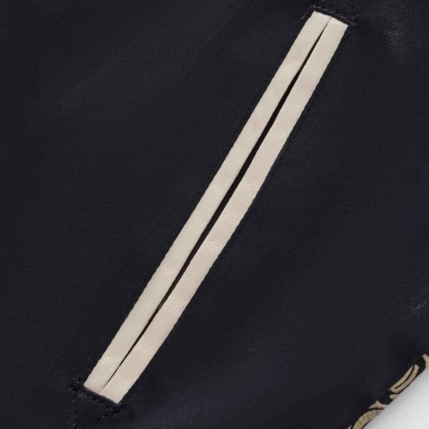 Close-up of slanted welt pocket with beige piping on navy body of Twin Dragons & Sakura sukajan jacket.