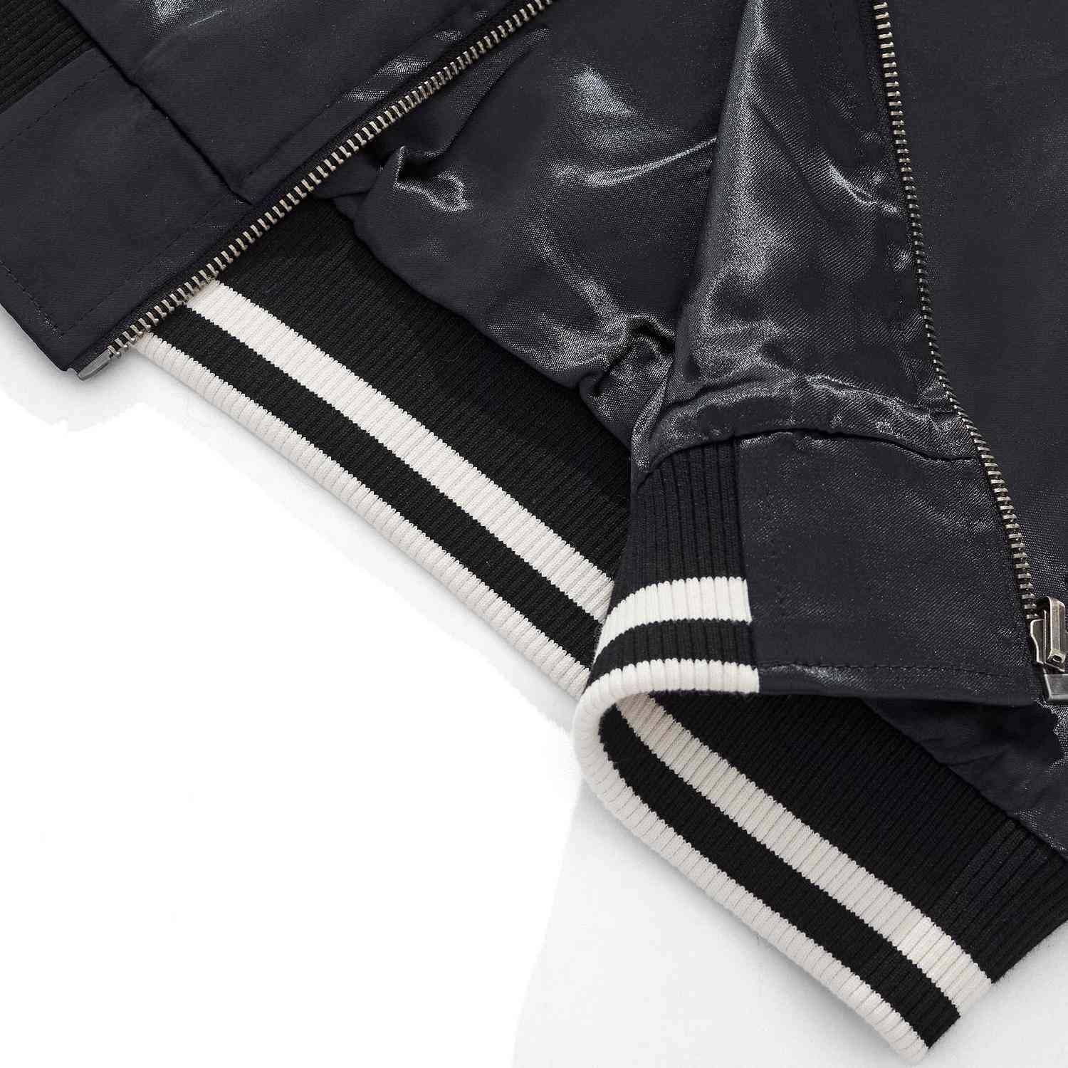 Detail of striped ribbed hem and zipper finish on Twin Dragons & Sakura Japanese sukajan bomber jacket.