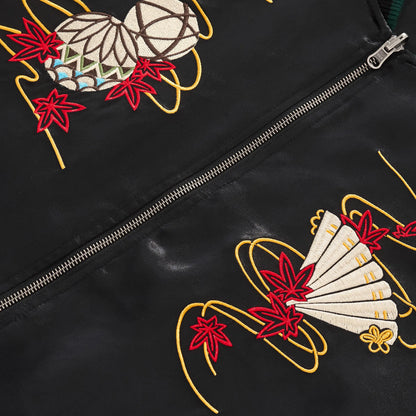 Detailed chest embroidery of a Japanese Temari ball and folding fan with maple leaves.