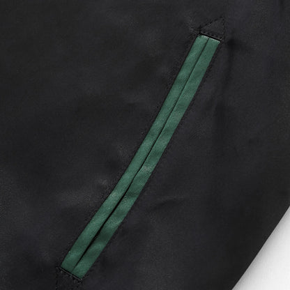 Reinforced side welt pocket detail with green trim.