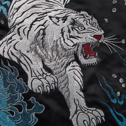 Back embroidery close-up of the tiger paws and blue flame texture