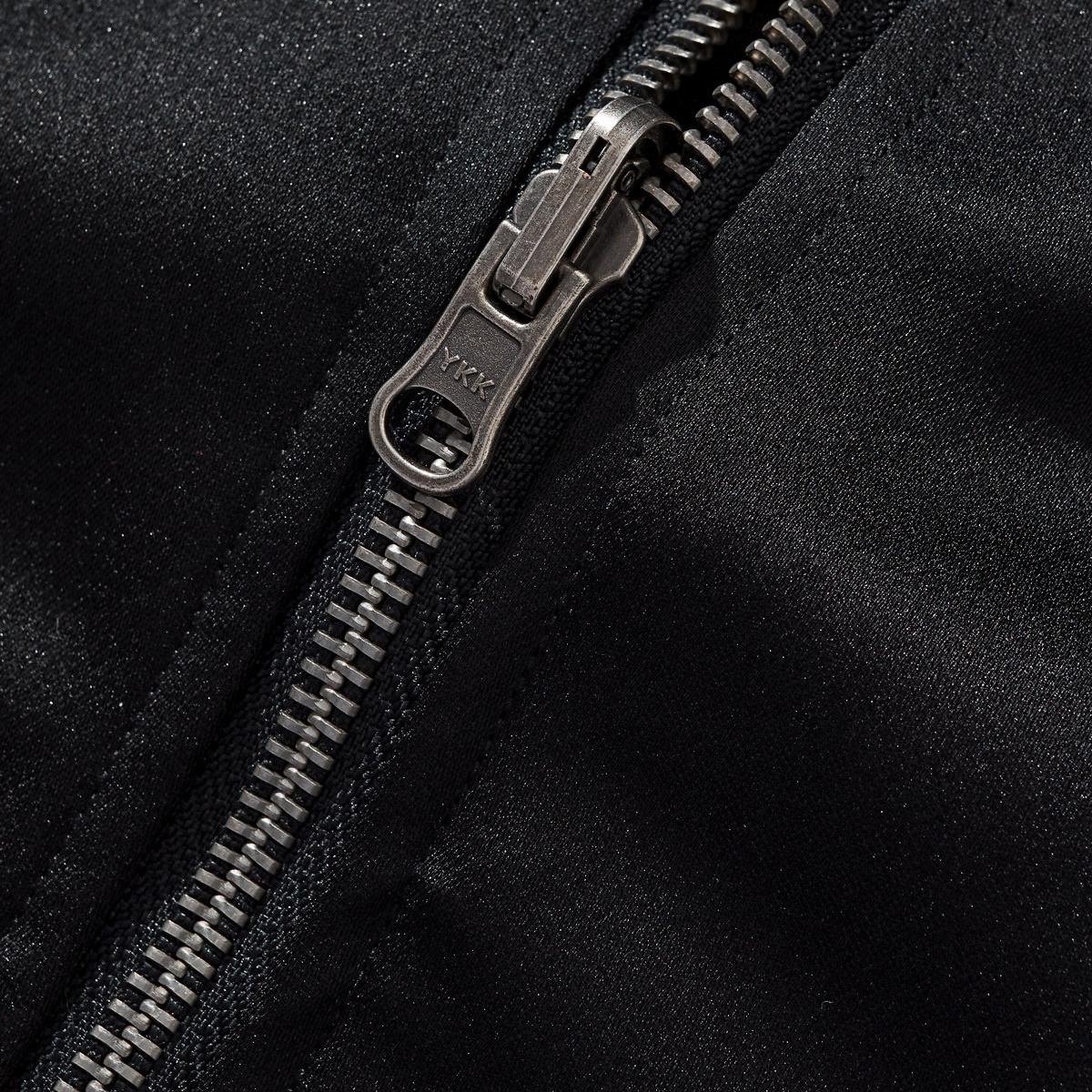YKK metal zipper pull close-up with sturdy teeth on sukajan jacket